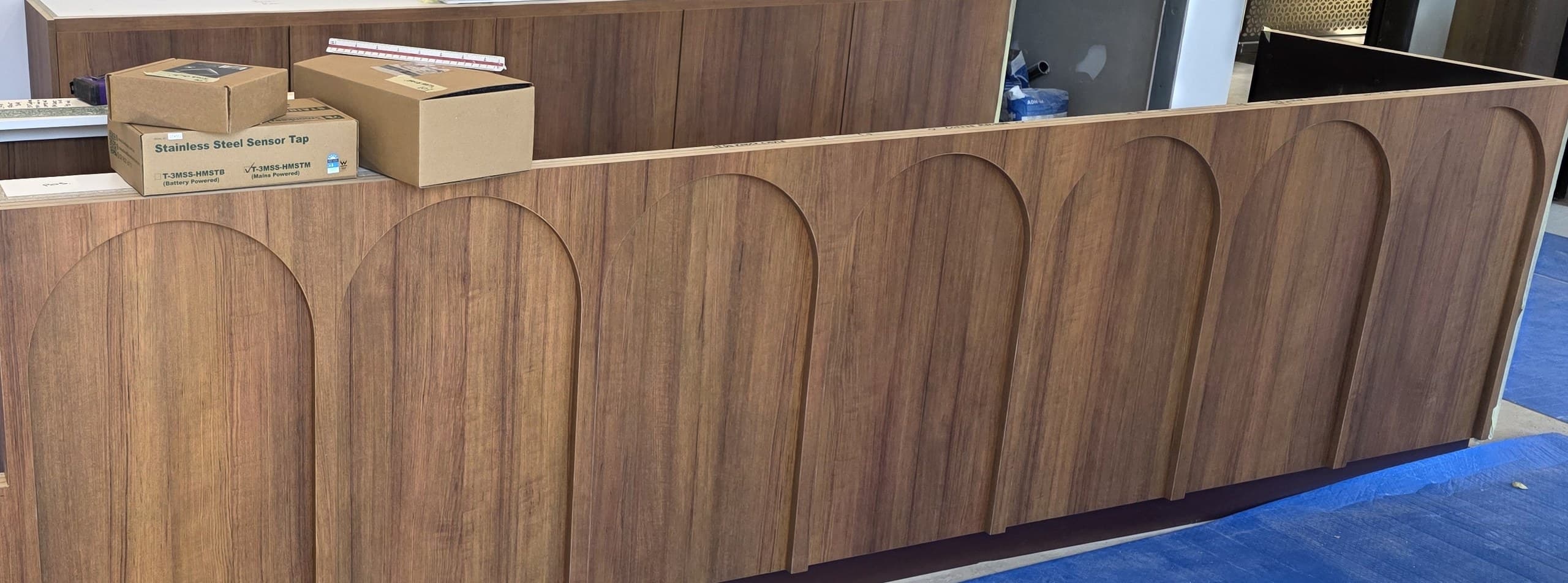 A timber veneer commercial counter with routed arch panel fronts, manufactured by AJT Commercial