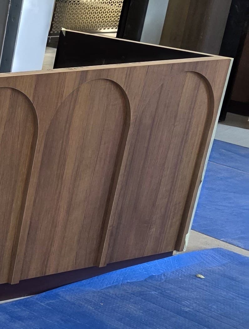 The mitred return at the end of the counter run, veneer carried around the corner
